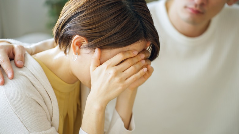 Upset woman covering face 