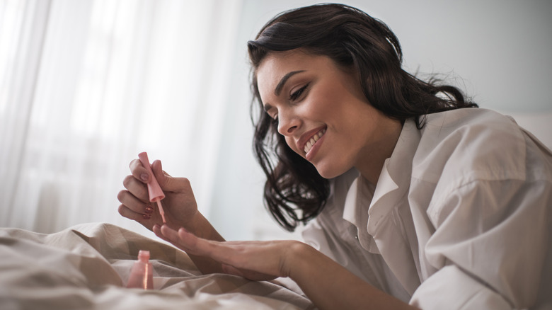 Woman applying nail polish
