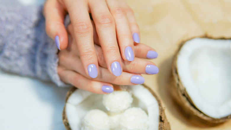 Hands next to coconuts