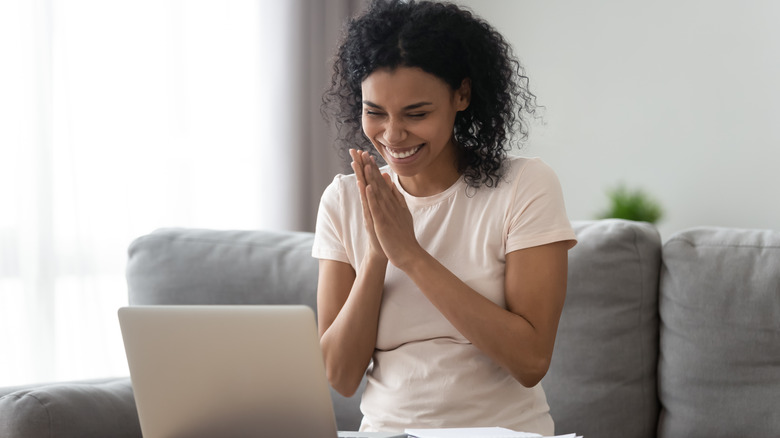 Woman celebrating at computer