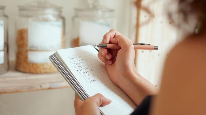 Woman making a shopping list