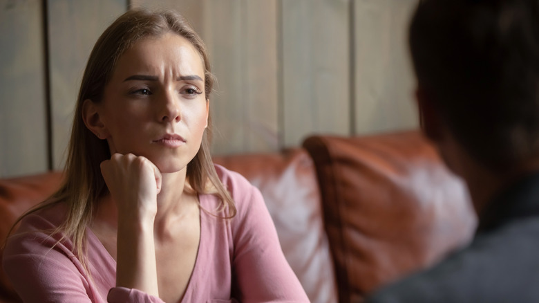 An unhappy looking woman on a date 