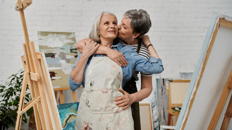 Mature lesbian couple in a painting studio