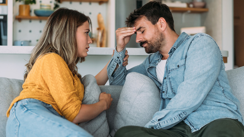 straight couple talking on couch