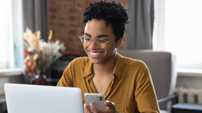 Woman smiling at laptop 