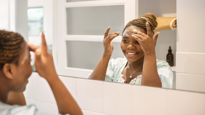 Woman applying acne cream