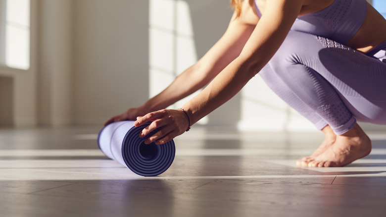 Unrolling yoga mat
