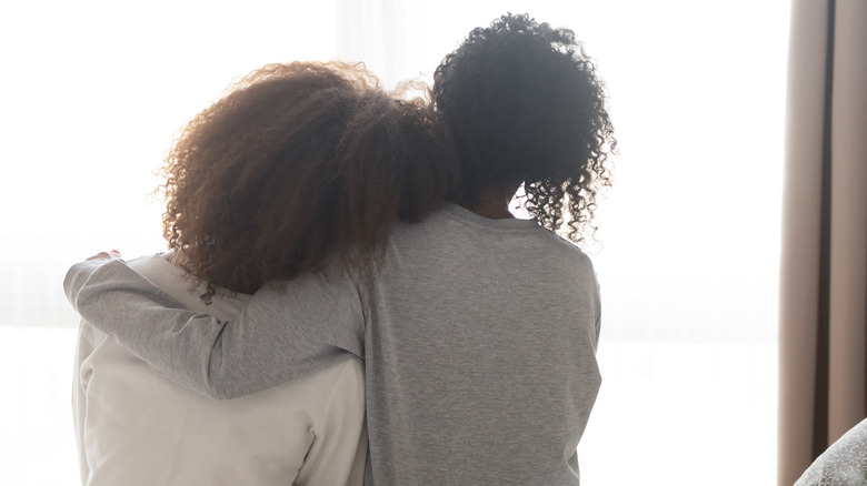 mother and daughter embracing