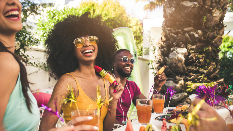 people celebrating with fruit and drinks