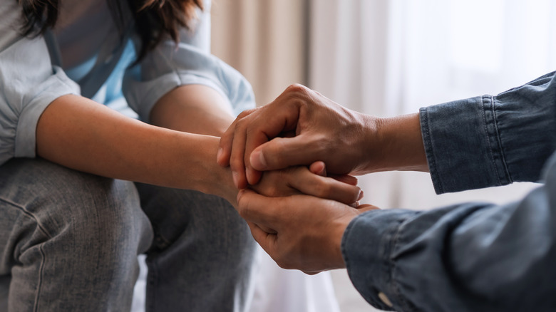 two people holding hands
