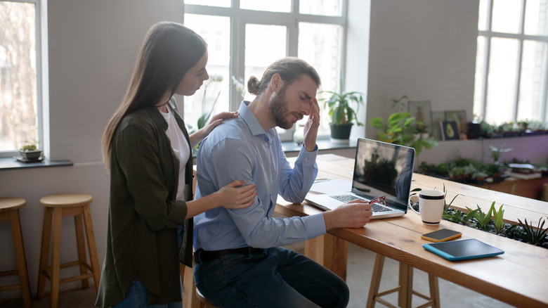 woman comforts man