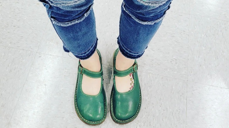 Closeup of feet in green mary janes