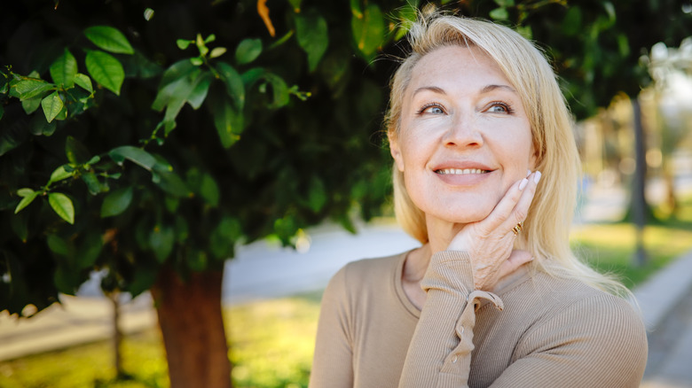 Older woman smiling outside