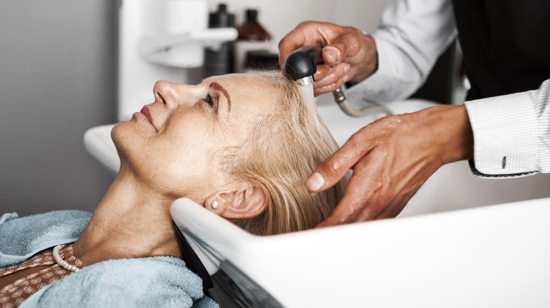 Older woman having hair washed