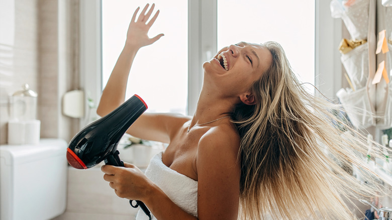 Woman with a blow dryer