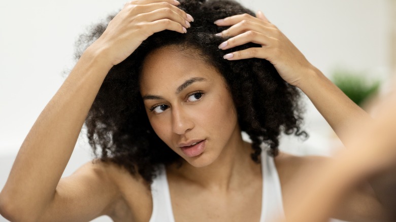 Woman touching her head