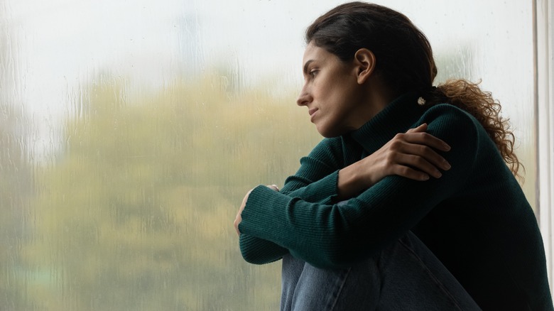 Woman hugging herself