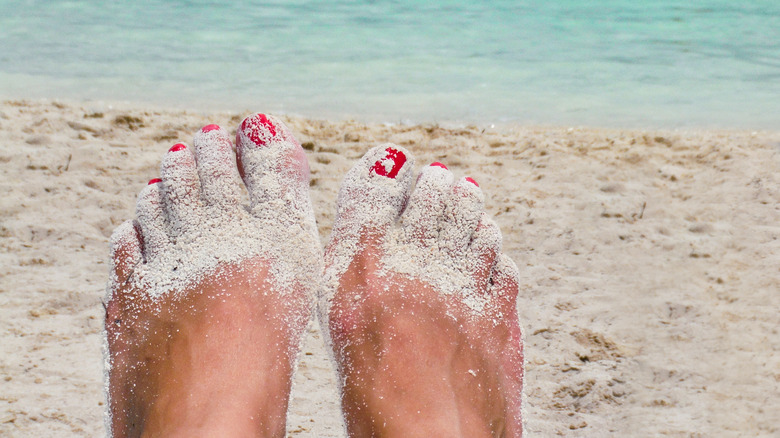 Woman's toes coated with sand