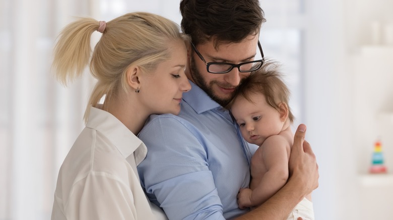 Peaceful parents holding newborn baby