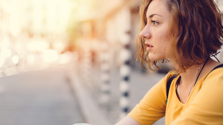 woman sits alone outside