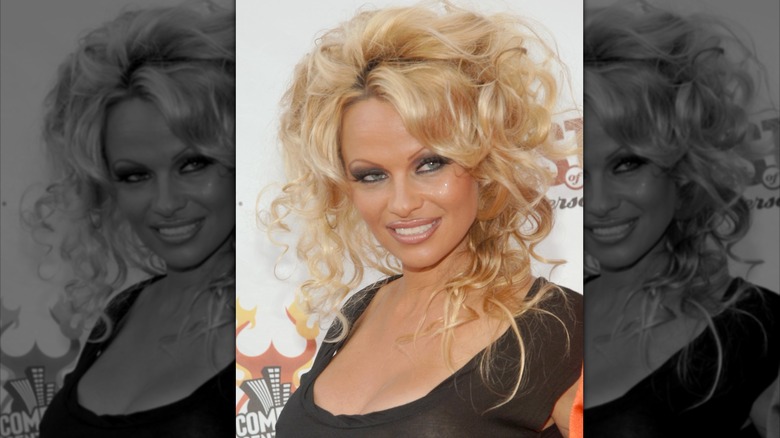 Pamela Anderson smiles on the red carpet in 2005