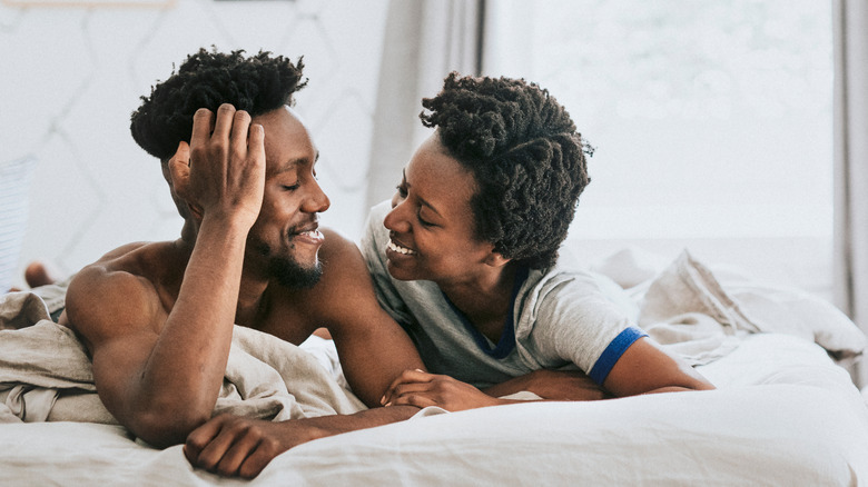 Couple in bed, smiling