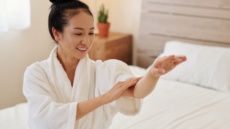 woman applying oil to skin