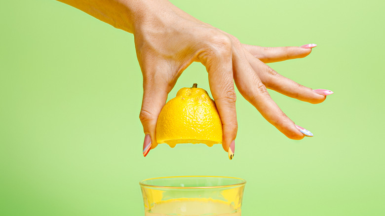 hand squeezing lemon