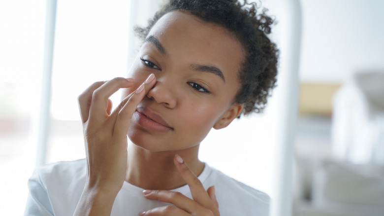 Applying eye cream