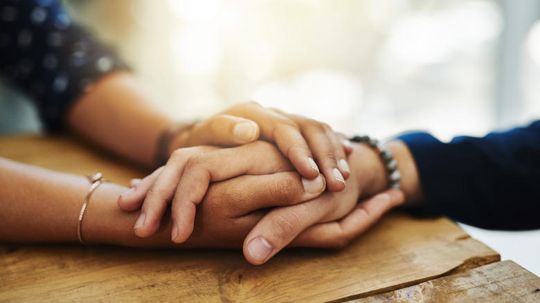 Friends holding hands
