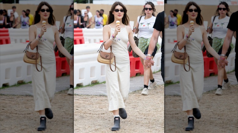 Daisy Edgar Jones wearing black chelsea boots with a biege dress