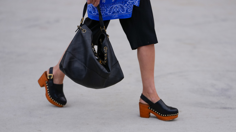 Woman walking wearing clogs