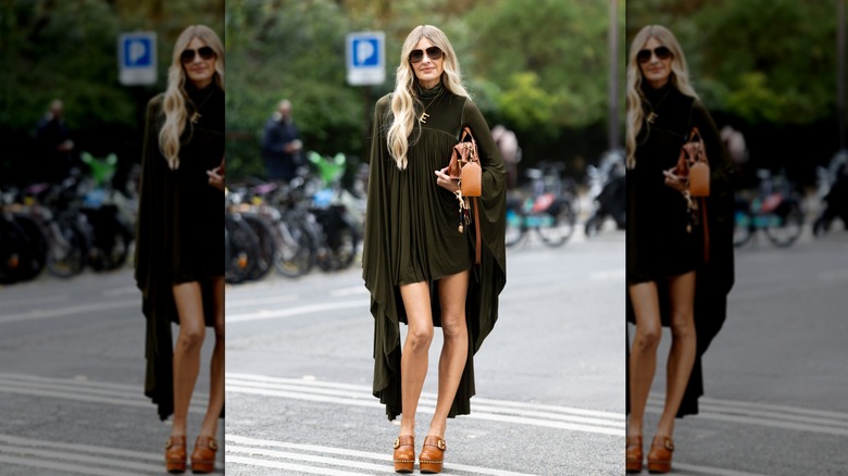 Elle Ferguson wears green pleated dress, brown bag, clogs outside Zimmermann during the Womenswear Spring Summer 2026