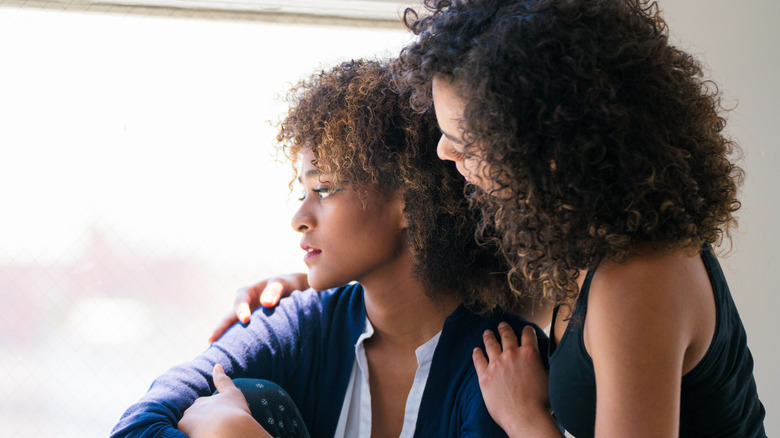 woman comforting woman