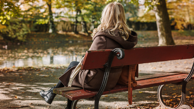 Woman sitting alone on bench