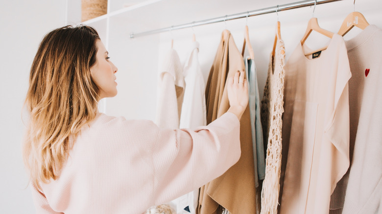 Woman looking through her closet