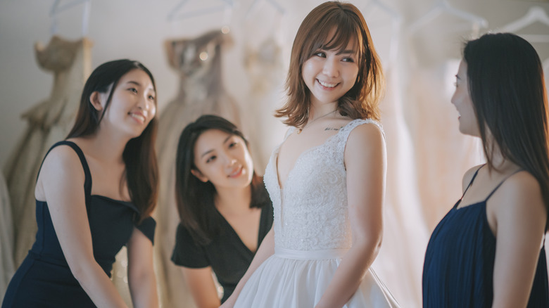 Bridesmaids helping the bride