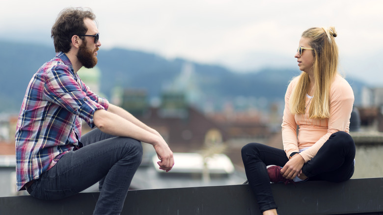 A couple talking outside 