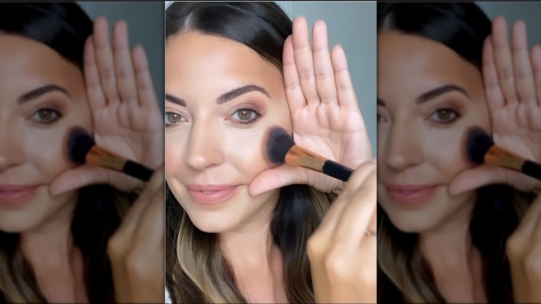 woman applying blush