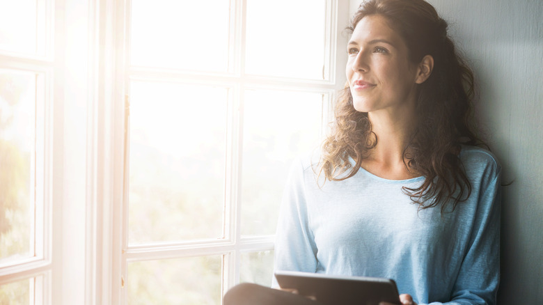 Woman on tablet against sunny day