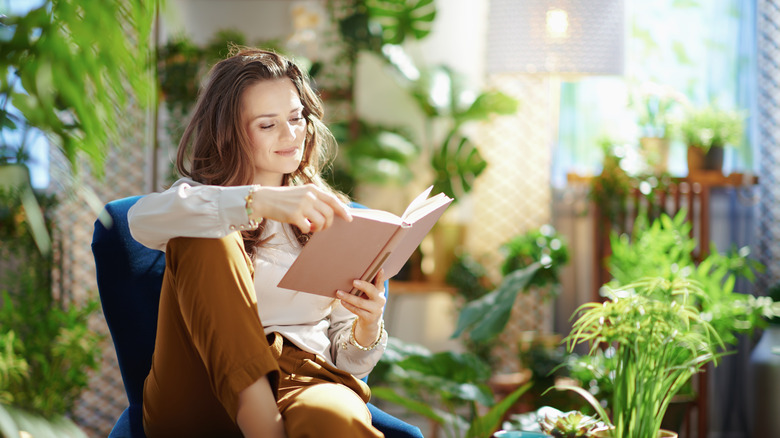 Woman reading book on sunny day