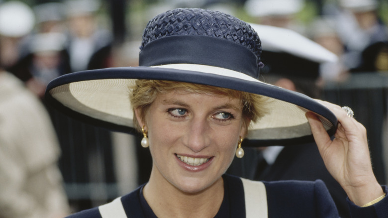 Princess Diana in a blue and white straw hat