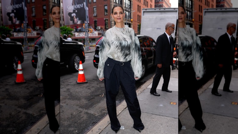 Katie Holmes in a slick ponytail with wide pants and a grey top
