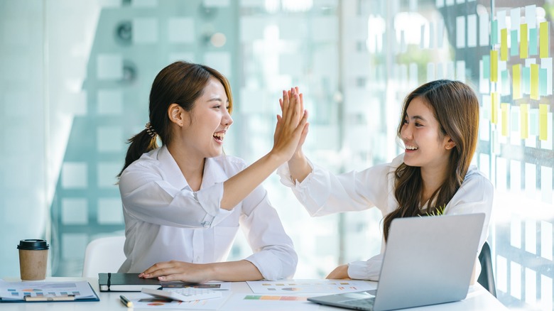 Women high fiving
