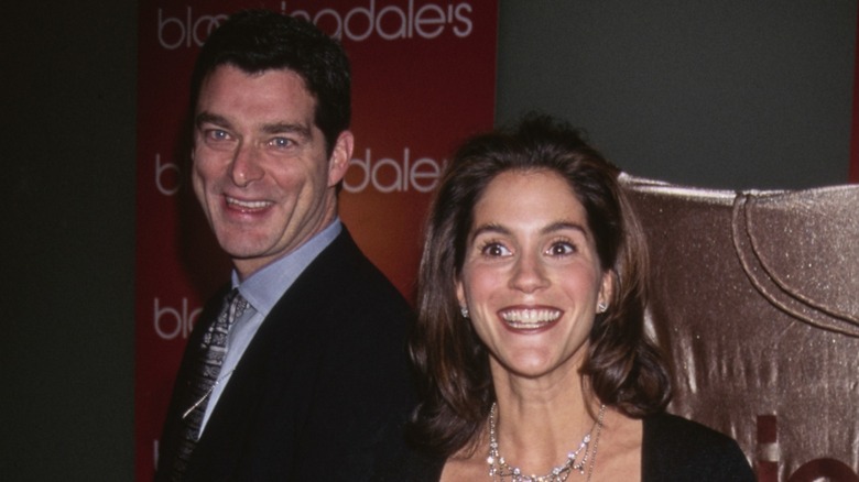 Jami Gertz and Tony Ressler smiling together at an event in 1996