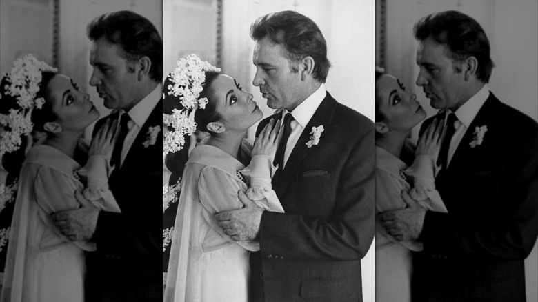 Black-and-white photo of Elizabeth Taylor leaning on Richard Burton