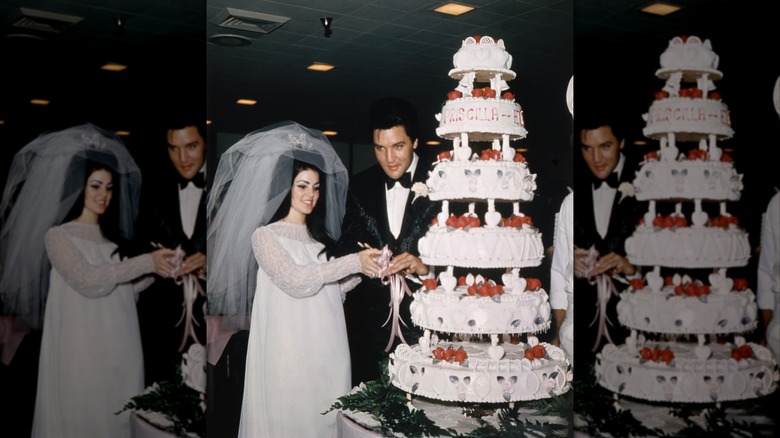 Priscilla Presley wearing a wedding dress and cutting her wedding cake while standing next to Elvis Presley