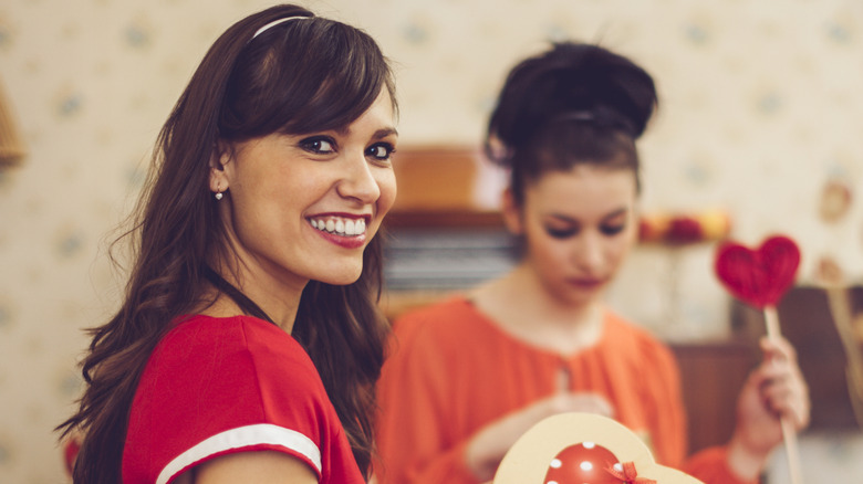 Two women holding Valentine's Day decorations
