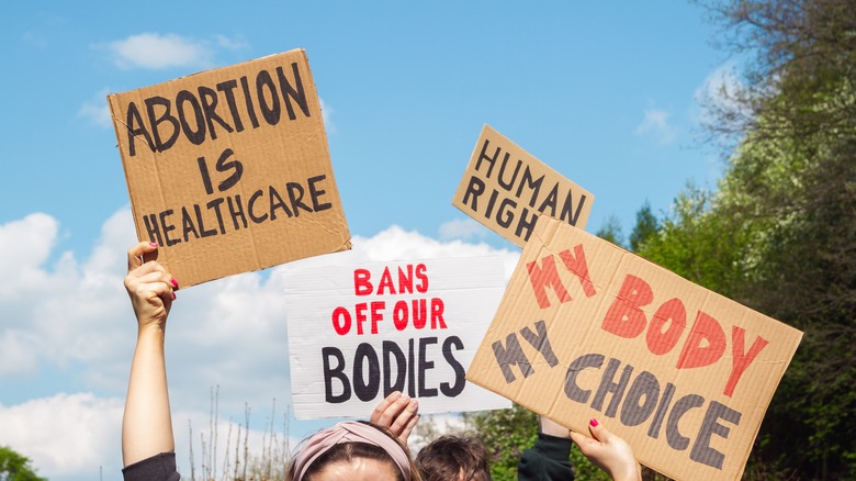 Protestors holding signs