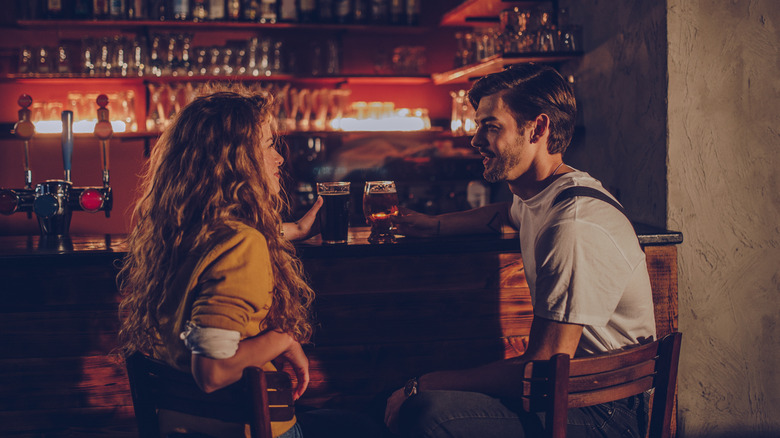 Couple flirting at bar